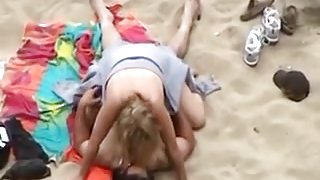 Dilettante pair having sex on the beach
