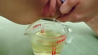 pee in measuring cup  close up